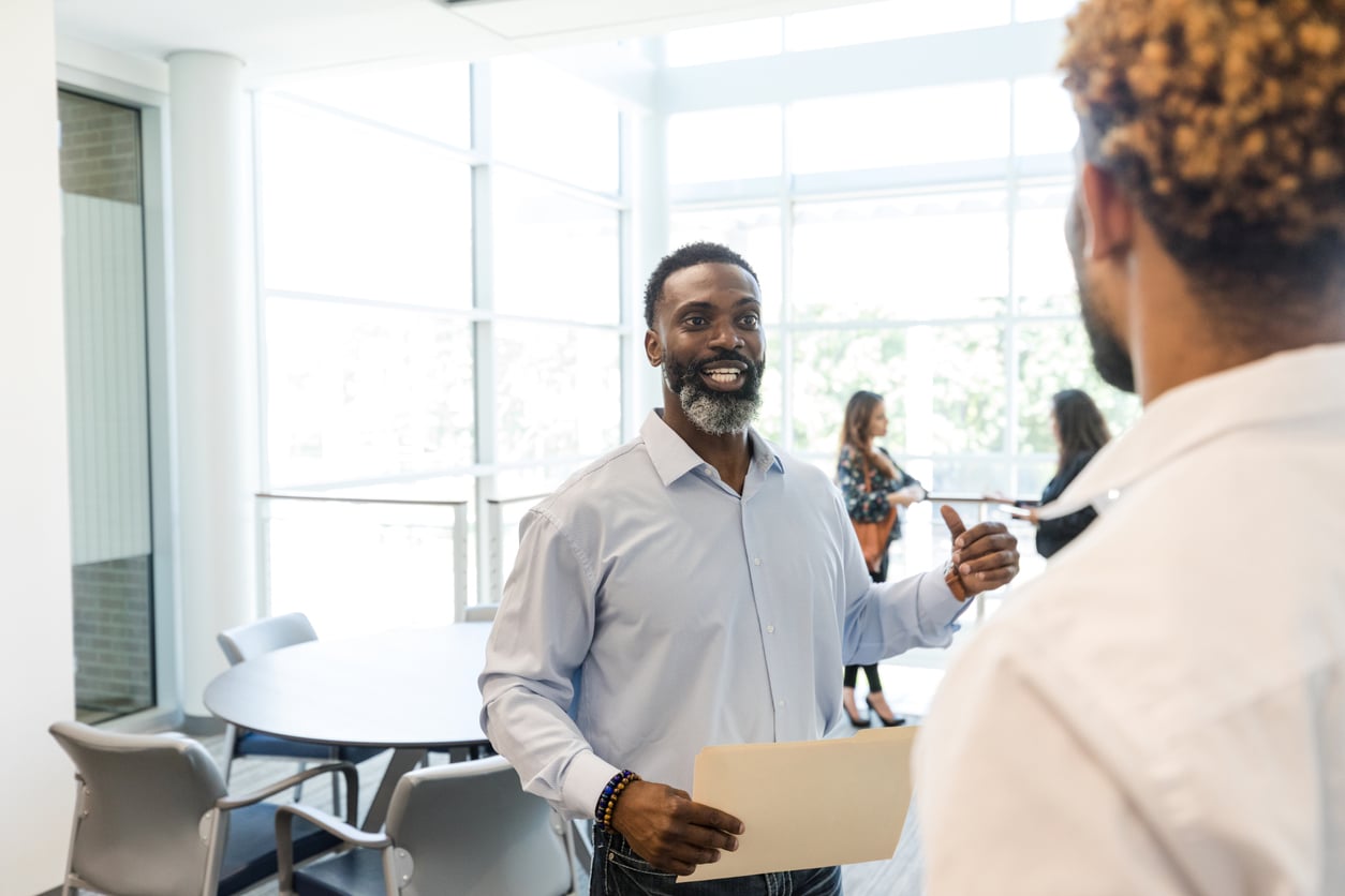 Two men meeting about to begin an interview