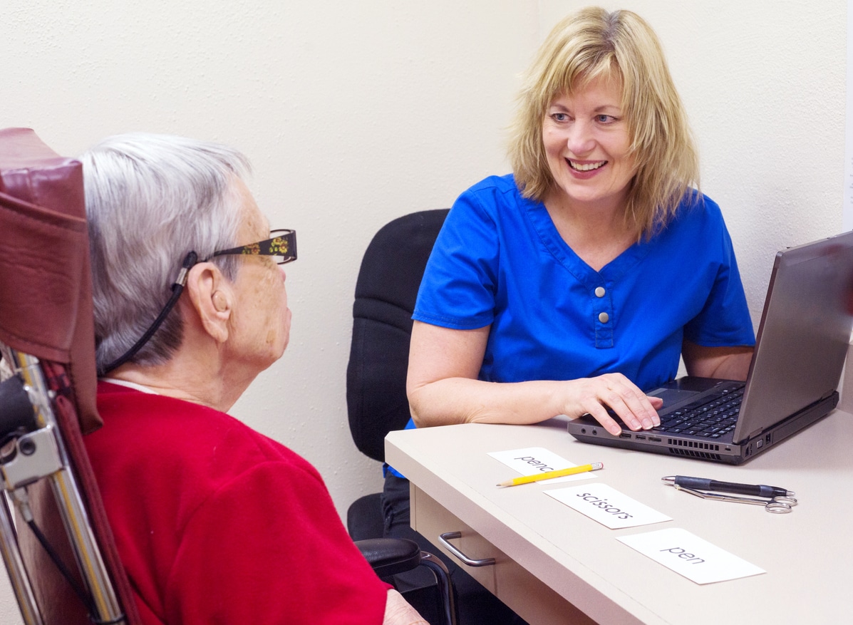 Woman with aphasia works with doctor