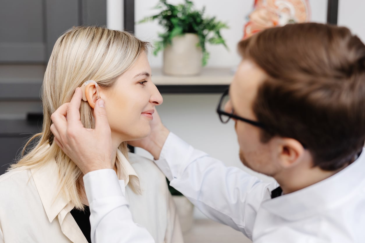 Young woman getting fit with new hearing aids
