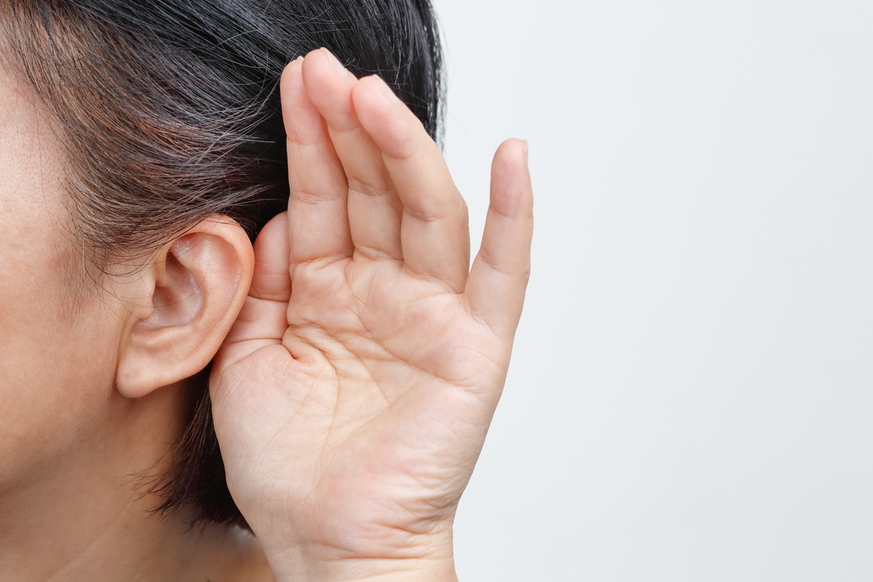 Hand to the ear, hearing concept